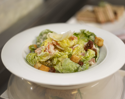A bowl of Caesar salad.
